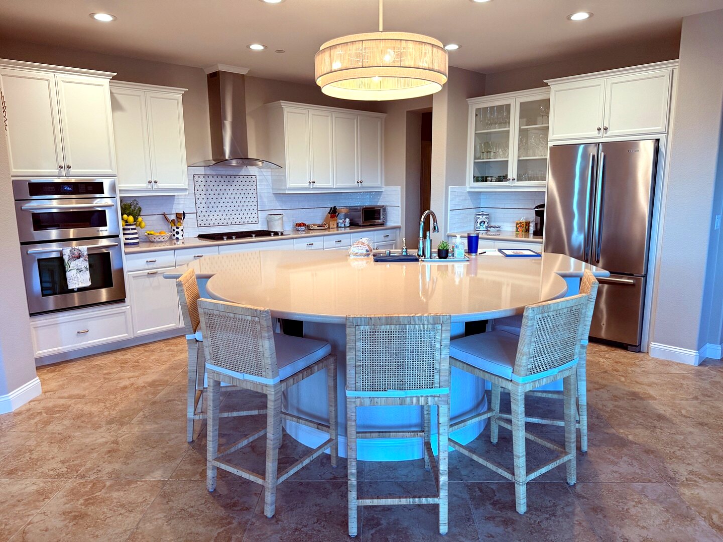 Kitchen with circular island and woven barstools