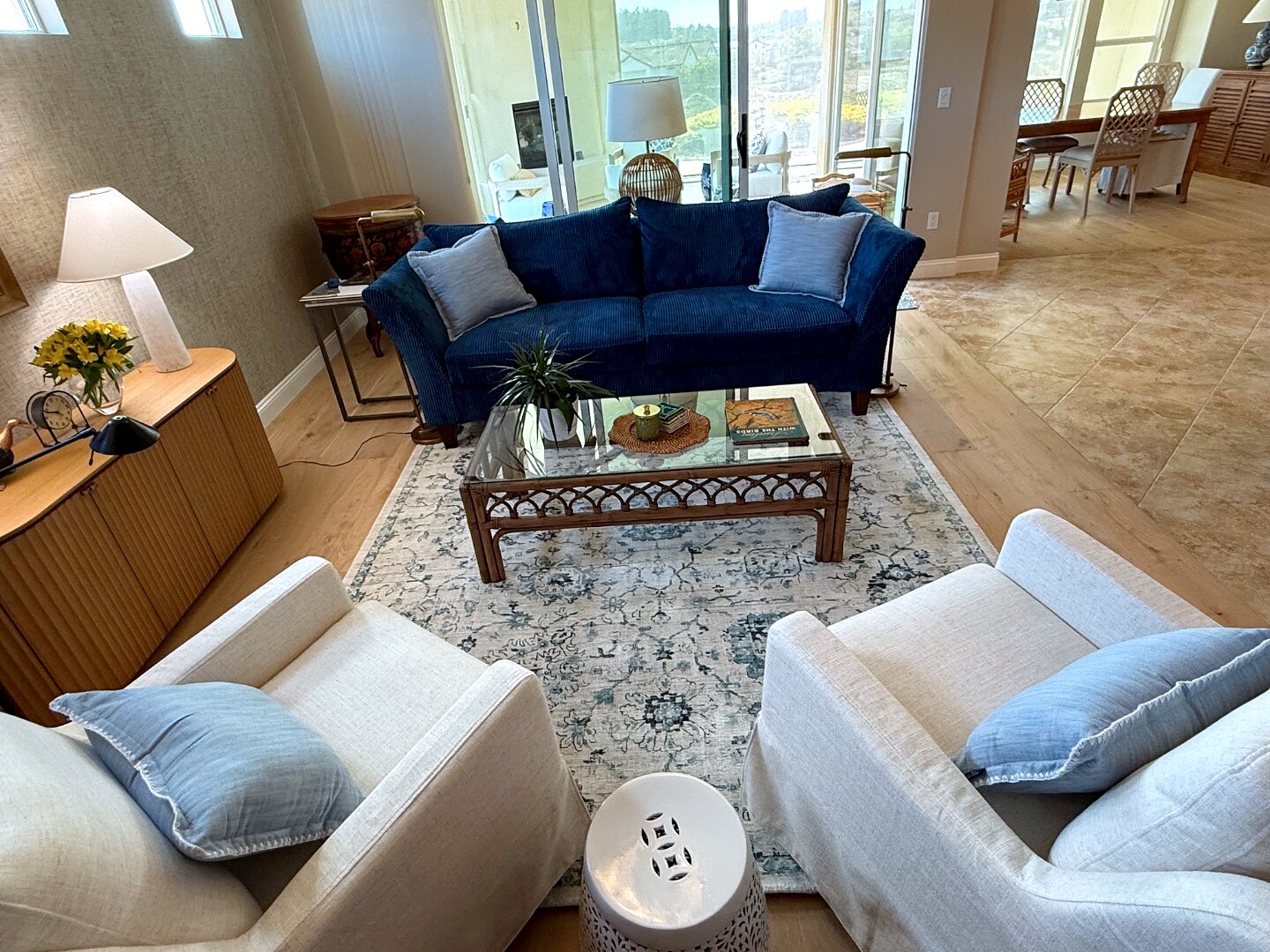 Layered living room with textured rugs, brass accents, and a mix of natural materials