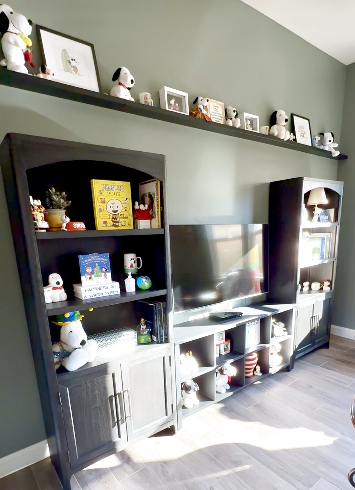 Snoopy collection room with a fine art print at the center and gallery walls built around every piece
