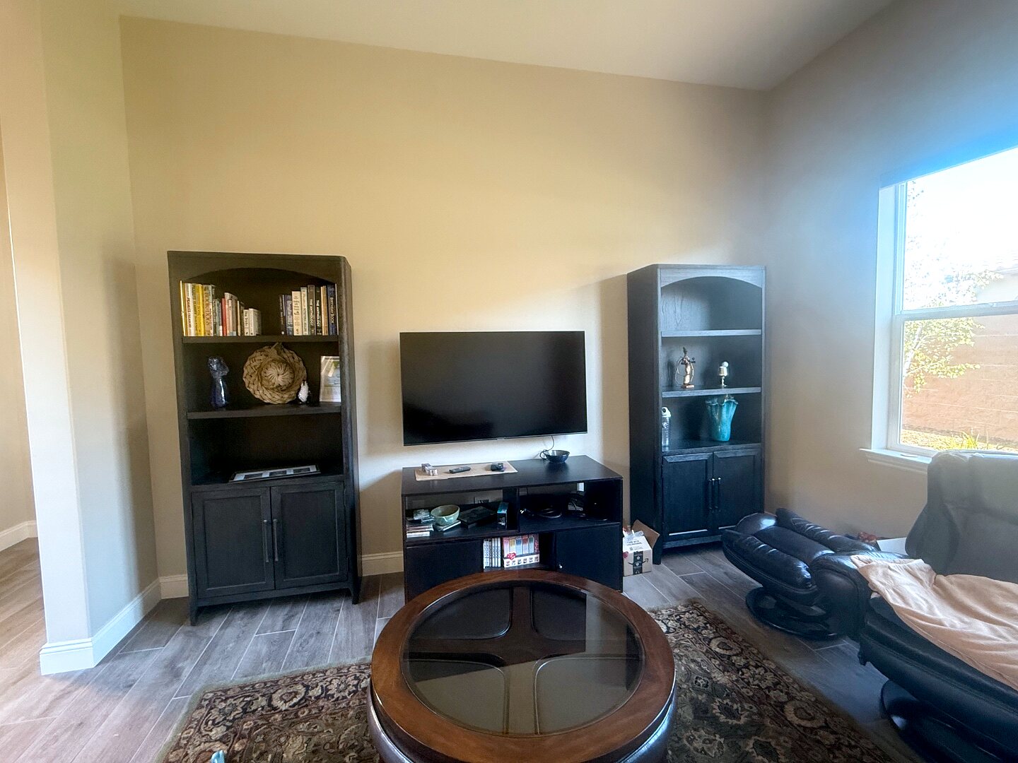 Snoopy room before — a plain media wall with a TV and bare shelves